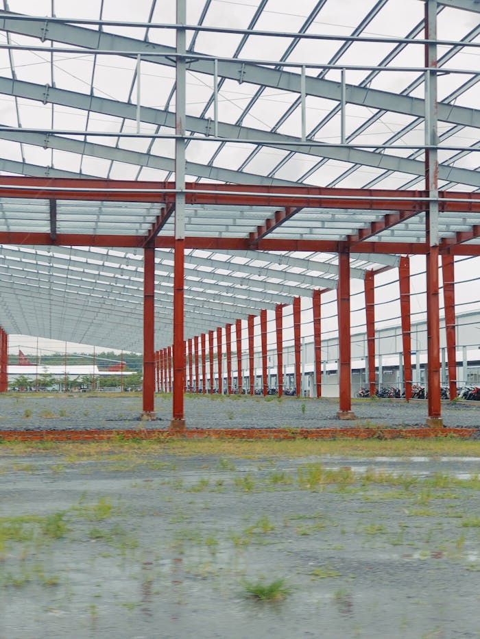 heros-img An expansive metal frame structure under construction in an open, industrial space.